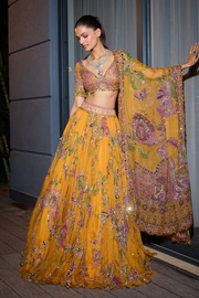 Mustard yellow floral lehenga with an embellished blouse and matching sheer dupatta.